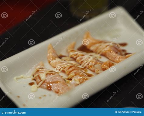 Torched Salmon Aburi Saikyo Sushi With Sweet Sauce On White Plate