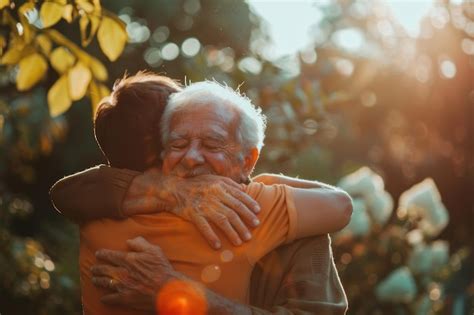 Portrait Of Happy Senior Father And Adult Son Hugging In Garden