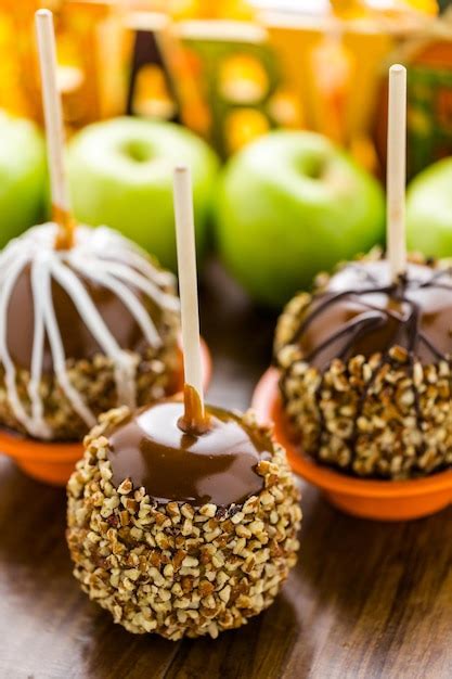 Premium Photo | Hand dipped caramel apples decorated for Halloween.