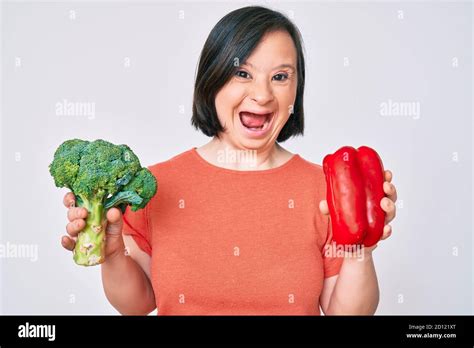 Brunette Woman With Down Syndrome Holding Broccoli And Red Pepper