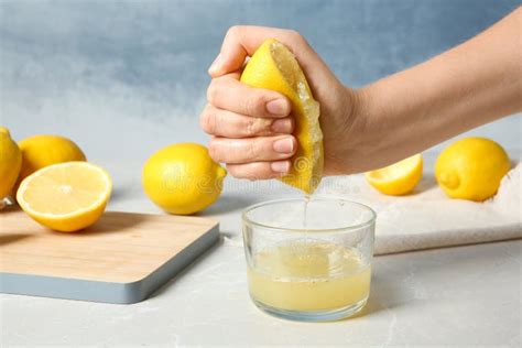 Woman Squeezing Lemon Juice Into Glass Stock Photo Image Of Juicy