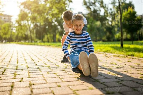 Little brothers playing in the park 24682188 Stock Photo at Vecteezy