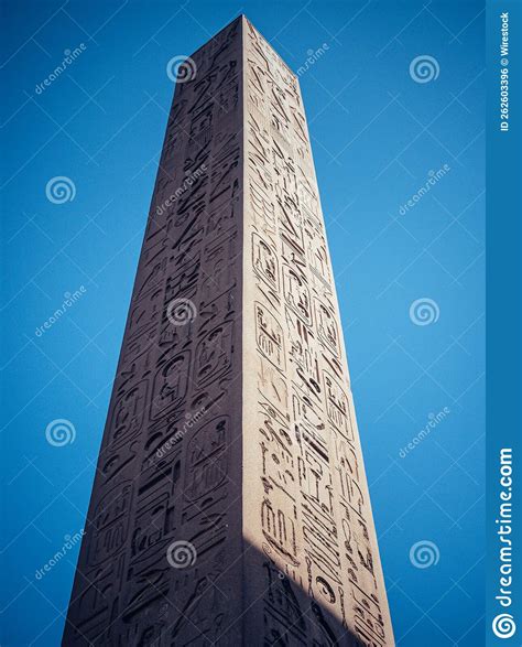 Vertical Low Angle Shot Of A Historic Obelisk With Carvings In The