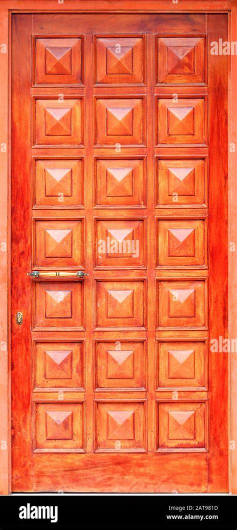 Old Wooden Entrance Doors With A Metal Bronze Handle Framed On The