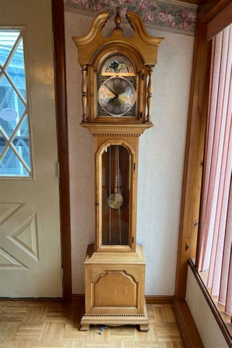 A Grandfather Clock Sitting In The Corner Of A Room