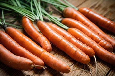 Premium Photo Fresh Carrots On A Wooden Table