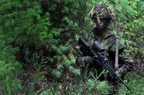 Camouflaged Soldier With Rifle 4k Ultra Hd Wallpaper