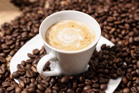 Premium Photo Coffee Late Cup And Roasted Beans On Table