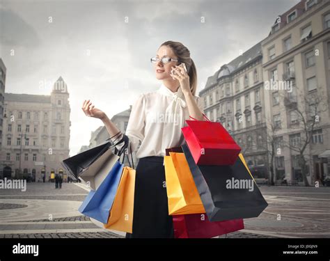 Blond Woman With Shopping Bags In The City Stock Photo Alamy