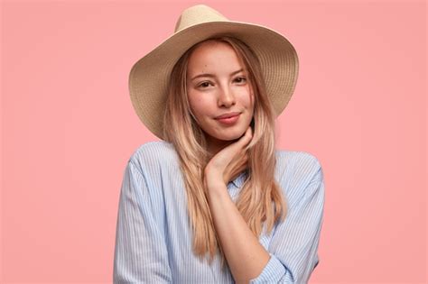 Free Photo Satisfied Woman With Delighted Expression Keeps Hand Under Chin Has Healthy Skin