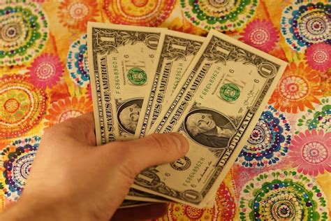 Premium Photo Cropped Hand Of Man Holding Paper Currency Over Floor