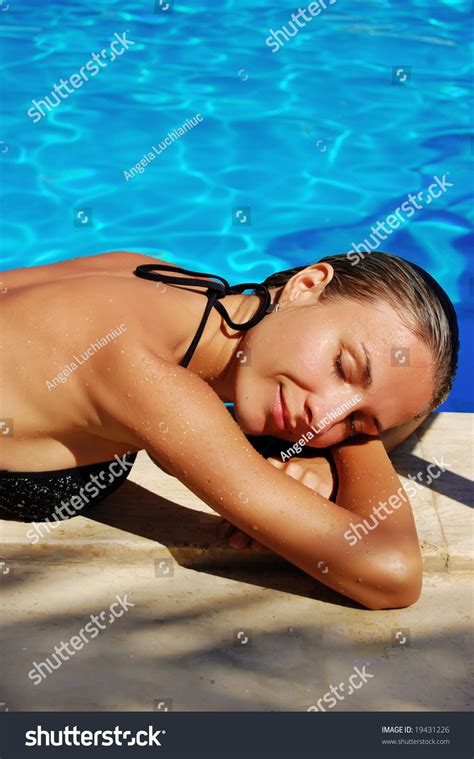 Beautiful Woman Laying In Bikini Near Swimming Pool Stock Photo