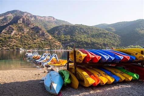 Premium Photo Multi Colored Boats By Sea Against Mountains