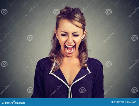 Portrait Of An Angry Frustrated Young Woman Screaming Stock Photo