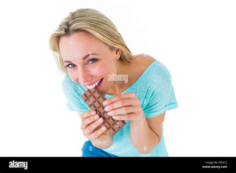 Pretty Blonde Eating Bar Of Chocolate Stock Photo Alamy