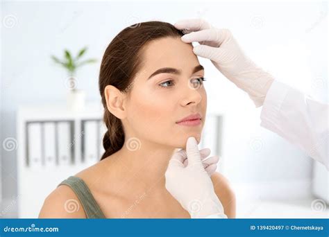 Dermatologist Examining Patient`s Face In Clinic Stock Image Image