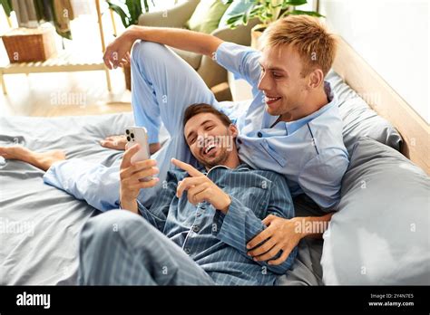 A Loving Gay Couple Shares A Lighthearted Moment In Their Pajamas Embracing Joy On A Serene