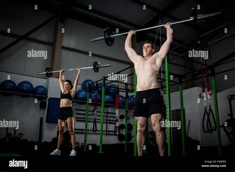 Man And Woman Lifting Barbell Stock Photo Alamy