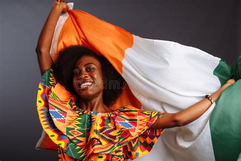 Happy African Woman In National Clothes Smiling And Posing With A Flag