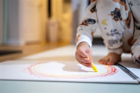 child drawing a crayon circle, Little kid drawing a circle with crayon stock photo