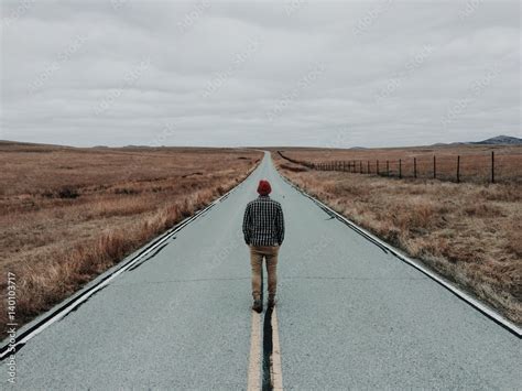 person standing middle road, Person person standing on middle of blacktop road during daytime people